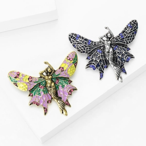 Creative angel brooches with colorful enamel wings and rhinestones on white display