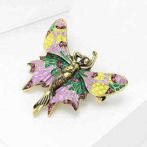 Close-up detail of angel brooch with purple enamel wings and pink rhinestone accents