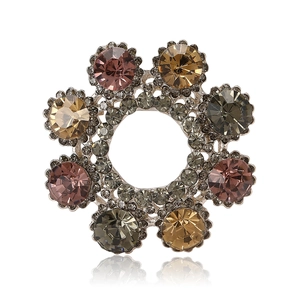 Vintage floral wreath brooch with colorful rhinestones and crystals on white background