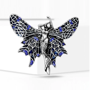 Macro detail of silver angel wings brooch with black enamel and blue rhinestones