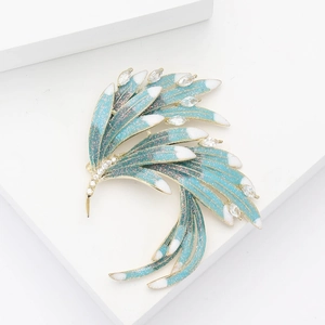 Elegant gold phoenix brooch with blue-green gradient feathers and micro-set cubic zirconia