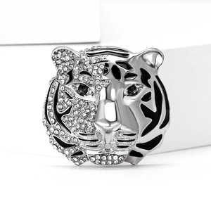 Macro detail of tiger head brooch with sparkling rhinestones and black enamel finish