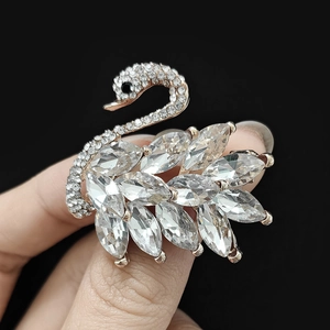 Detail of elegant swan ring with rose gold plating and white crystal wings on finger