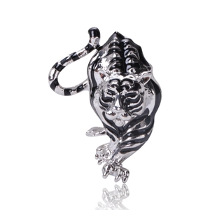 Detailed close-up of tiger brooch with silver alloy texture and black enamel stripes