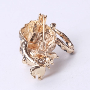 Detail view of the golden beetle brooch back showing the secure clasp and enamel plating