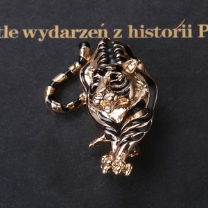 Detailed close-up of a golden tiger brooch with black enamel stripes and realistic textures