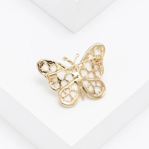 Detailed view of the butterfly brooch back showing the gold plating and secure pin closure