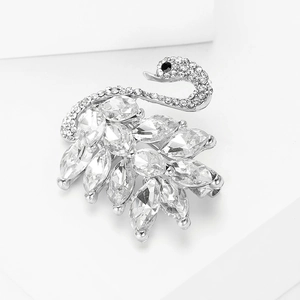 Detail of silver swan brooch featuring sparkling crystal inlay and elegant wing texture