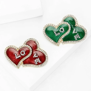 Elegant heart-shaped brooches with sparkling crystals and 'LOVE' text in red and green