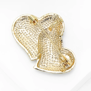 Golden double heart brooch back view with textured alloy finish and safety pin clasp