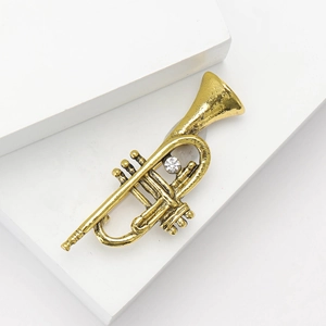 Vintage gold flute brooch for suits with textured metal and sparkling zircon stone inlay