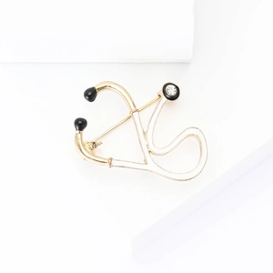 Creative alloy stethoscope brooch with gold plating, black enamel, and clear rhinestone accent