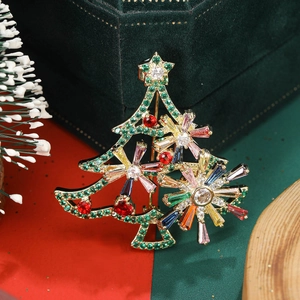 Close-up of a rotating hollow Christmas tree brooch with colorful zircons on a velvet box