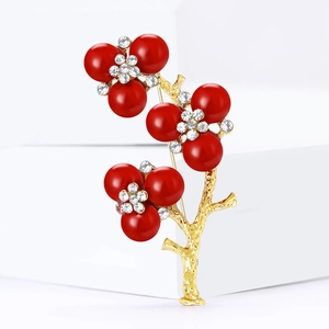 Elegant Chinese plum blossom brooch with red beads and rhinestones in gold finish