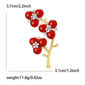 Elegant gold flower brooch with red beads and white rhinestones, size 5.7x3.1cm