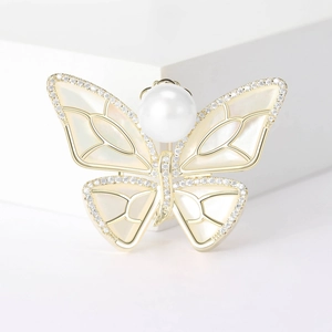 Exquisite gold-plated butterfly brooch with iridescent mother of pearl and a large white pearl