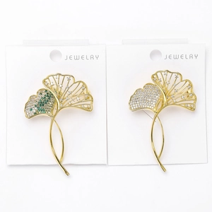 Close-up of ginkgo leaf brooches with gold plating and micro-pave cubic zirconia
