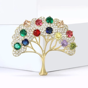 Exquise broche arbre de vie avec zircons colorés sur base en métal doré