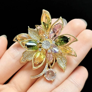 Macro view of floral brooch featuring colorful zircons and marquise-cut stones