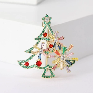 Close-up of golden Christmas tree brooch with colorful cubic zirconia and star detail