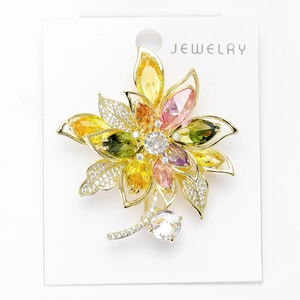 Close-up of elegant flower brooch with colorful cubic zirconia and gold-plated alloy details