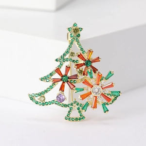 Detail of a gold Christmas tree brooch with colorful sparkling zircon gemstones and star