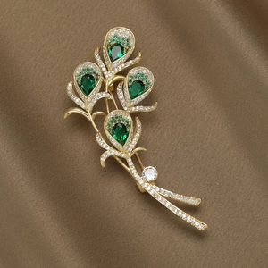 Elegant peacock feather brooch with green crystals and micro-set cubic zirconia accents