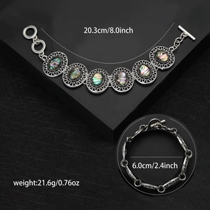 Vintage luxury abalone shell bracelet with ornate silver hollow carving and toggle clasp