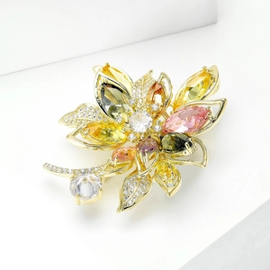 Elegant gold flower brooch with colorful cubic zirconia crystals in 45-degree angle view