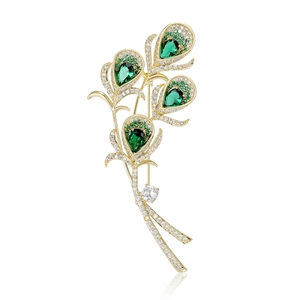Elegant peacock feather brooch with emerald green crystals and white zircon accents