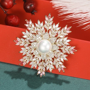Elegant gold snowflake brooch with pink zircon crystals and a center white pearl