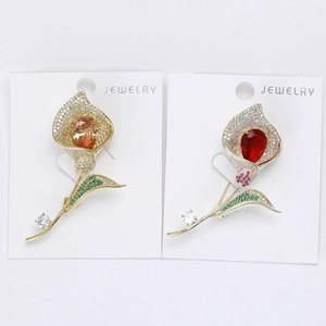 Vue détaillée de broches d'arums élégantes avec des gemmes orange et rouges en poire