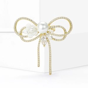 Broche nœud élégante avec perle blanche, fleur de nacre et oxydes de zirconium