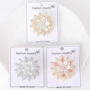 Three elegant marquise zircon lotus flower brooches on fashion jewelry display cards