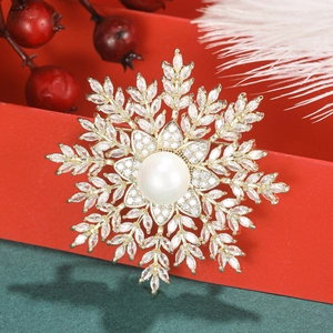 Detailed macro view of a layered snowflake brooch with a large pearl and zircon inlay
