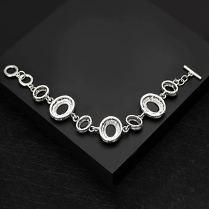 Detail of vintage silver link bracelet with hammered texture and toggle clasp design