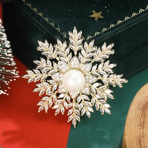 Detail view of snowflake brooch with white pearl and zircons on green velvet box