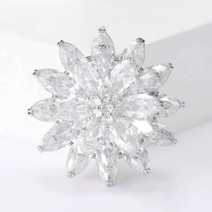 Macro shot of silver sparkling zircon lotus brooch with marquise cut stones and floral detail