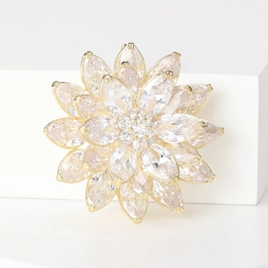 Macro shot of 3D layered lotus brooch with marquise-cut cubic zirconia in gold setting