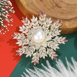 Close-up of snowflake brooch with pearls and zircon on a festive Christmas background