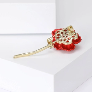 Elegant red rose brooch with gold metal stem and white rhinestone details in main view