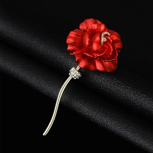 Detail of red rose brooch with tiered lacquer petals and crystal-encrusted gold-tone sepals