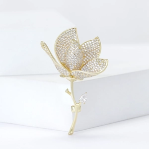 Elegant gold tulip brooch with micro-paved cubic zirconia and pear-cut crystal leaf