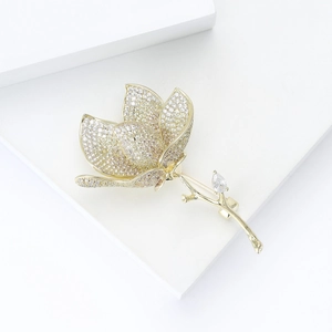 Close-up of elegant tulip brooch with white cubic zirconia inlay and gold metal stem