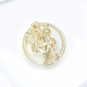 Close-up of the back pin fastening and structure on a gold pearl brooch with cubic zirconia