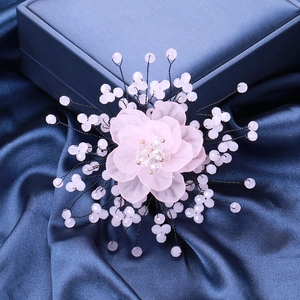 Detail view of pink crystal flower brooch with handmade beads and soft silk petals