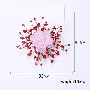 Pink gauze petal flower brooch with crystal beads and pearls on a white display card