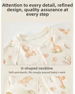 Detail of baby romper featuring snap buttons and cute cartoon giraffe animal prints