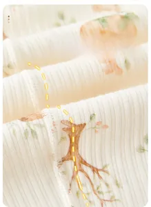 Close-up of baby clothing fabric showing four-needle six-thread flat seam construction
