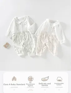 Detail of baby cotton long-sleeve rompers showing A-class safety labels and soft textures